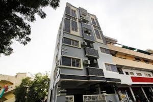 a tall white building with solar panels on it at Jubilee Homes in Hyderabad