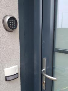 a door with a phone on the side of a building at Studio Castel Binic in Pordic