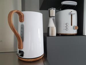 a white appliance sitting on a counter next to a toaster at Studio Castel Binic in Pordic +24 photos