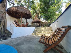 a couple of chairs and umbrellas next to a wall at Hotel Zazil-Naj in Valladolid