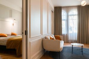 a bedroom with a bed and a chair and a table at Park Hotel Viljandi in Viljandi