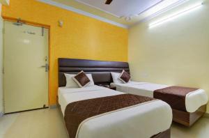 מיטה או מיטות בחדר ב-HOTEL GARDEN VILLA