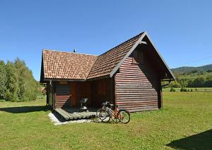una bicicleta estacionada frente a un pequeño edificio en Chalets Zelena Vrata en Fužine
