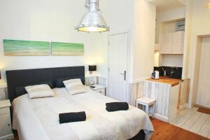 a bedroom with a bed with two pillows on it at Grand Apartments - Anchor Apartament Sopot in Sopot