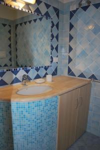 y baño con lavabo y espejo. en Appartamenti Golfo Aranci, en Golfo Aranci