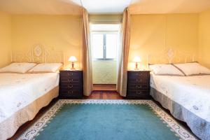 En eller flere senge i et værelse på Villa Douro