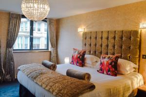 a bedroom with a large bed and a large window at Posh Pads - Liverpool 1 - Apart-Hotel in Liverpool