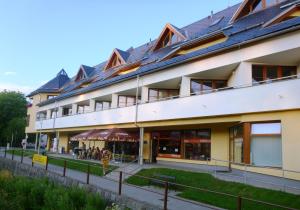 a large building with people sitting outside of it at Apartmán Velké Losiny in Velké Losiny +5 photos