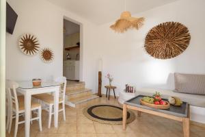 a living room with a couch and a table at Mirabeli Apartments & Suites in Pollonia