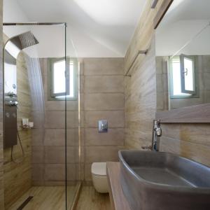 a bathroom with a sink and a toilet at Mirabeli Apartments & Suites in Pollonia