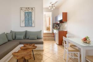 a living room and kitchen with a couch and a table at Mirabeli Apartments & Suites in Pollonia