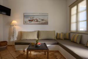 a living room with a couch and a table at Mirabeli Apartments & Suites in Pollonia