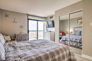 a bedroom with a bed and a balcony at Beachfront Ocean City Condo with 2 Balconies and Views in Ocean City