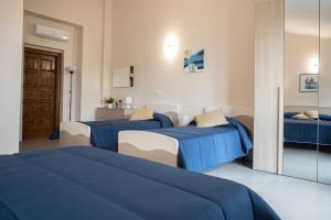 A bed or beds in a room at Un passo dal mare - Guest House