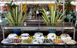 a display case with cakes and other desserts on display at Barceló Tambor - All Inclusive in Tambor