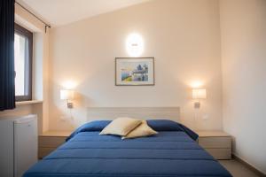 A bed or beds in a room at Un passo dal mare - Guest House