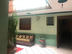 a living room with a couch in the corner of a room at San Pablo in Pátzcuaro