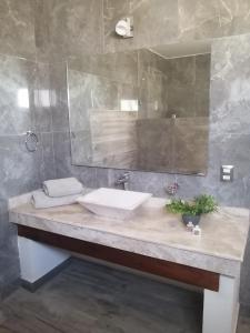 bagno con lavandino e specchio di Hotel San Diego a Bernal