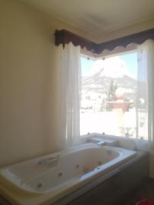 a bath tub in a bathroom with a window at Hotel San Diego in Bernal