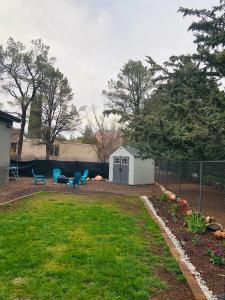 a yard with a shed and chairs and a fence at Sedona Red Rock Garden of Paradise Pets friendly and Hot tub in Sedona