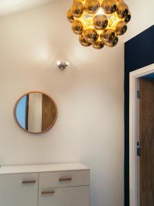 a mirror and a chandelier in a bathroom at Regent House deluxe 1 bedroom apartment in Harrogate