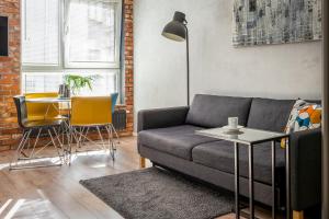 a living room with a couch and a table at apartamenty-wroc Golden House in Wrocław