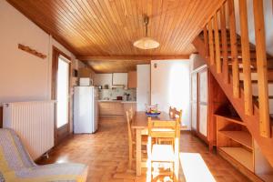 a kitchen and dining room with a staircase in a house at Appartement de 2 chambres avec jardin et wifi a Arvieux a 1 km des pistes in Arvieux