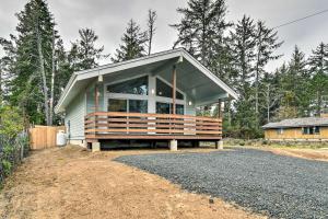 a small house with a porch on a dirt road at Cozy Cottage on the Coast Near Downtown Westport! in Westport