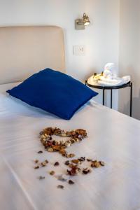 a pile of nuts on a bed with a blue pillow at Appartamento Comballo in Lezzeno