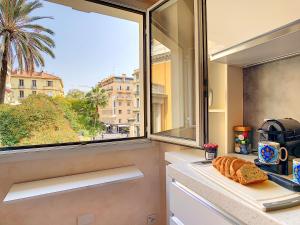 a kitchen with a window with a loaf of bread on a counter at Nestor&Jeeves - LE DUPLEX - Central - Very close sea in Nice