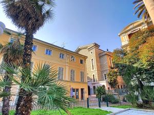 a large yellow building with a palm tree in front of it at Nestor&Jeeves - LE DUPLEX - Central - Very close sea in Nice