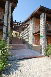 a building with a staircase leading to a house at Appartamenti Borgo in Gardone Riviera