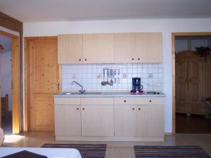 a kitchen with white cabinets and a sink at Bachtelhuber-Hof in Teisendorf