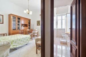 a kitchen and living room with a table and a dining room at Apartment with balcony in Porto Santo Stefano 89 m² sea view in Porto Santo Stefano