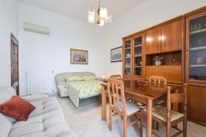 a living room with a table and a couch at Apartment with balcony in Porto Santo Stefano 89 m² sea view in Porto Santo Stefano