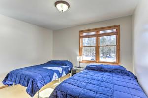 A bed or beds in a room at Catskills Cabin Escape with Deck and Fire Pit!