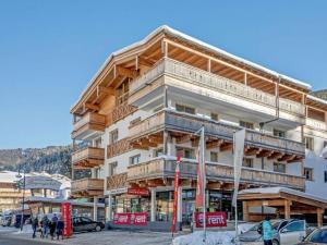 a large building with wooden balconies on a street at Top location Gerlos! - Lovely Apartment - 6P in Gerlos