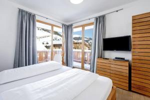 a bedroom with a bed and a large window at Lovely Spacious Apartment Gerlos -Owner- in Gerlos