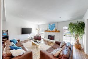 a living room with a couch and a fireplace at Fun Times in the Colony in The Colony