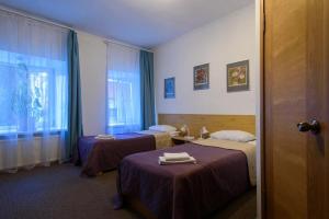 a hotel room with two beds and a window at Pushkinskaya 8 mini-hotel in Saint Petersburg