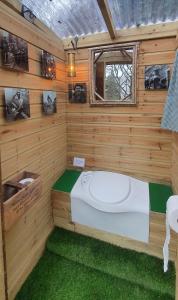 a room with a bed in a wooden wall at Miners log cabin in Blaina