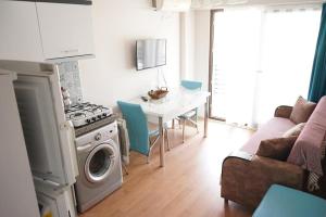 a kitchen with a stove and a table with chairs at Ören Konak Apart in Burhaniye