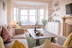 a living room with a table and a fireplace at Tower House, Aldeburgh in Aldeburgh