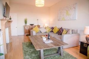 a living room with a couch and a table at Tower House, Aldeburgh in Aldeburgh
