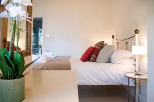 a bedroom with a bed and a mirror at Tower House, Aldeburgh in Aldeburgh