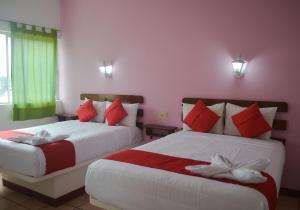 Ein Bett oder Betten in einem Zimmer der Unterkunft Hotel Kashlan Palenque