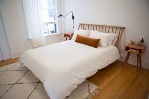 a bedroom with a large white bed with white sheets at Object Hotel 2BR Room 2A in Bisbee