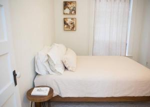 a bedroom with a bed with white sheets and pillows at Object Hotel 2BR Room 2A in Bisbee