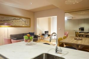 a kitchen and living room with a sink and a table at ChillHouse_Porto - Praça da República in Porto