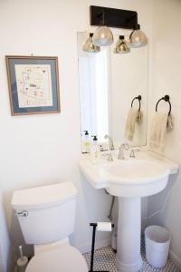 a bathroom with a white toilet and a sink at Object Hotel 1BR Shared Bath Room 2C in Bisbee +16 photos